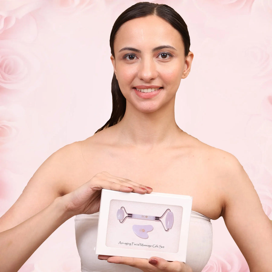 Woman holding anti-aging facial massage gift set with rose quartz roller and gua sha for glowing skin