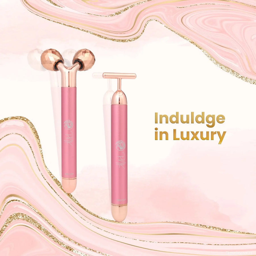 Pink rose gold facial roller and gua sha tool for luxury skincare routine on marble background